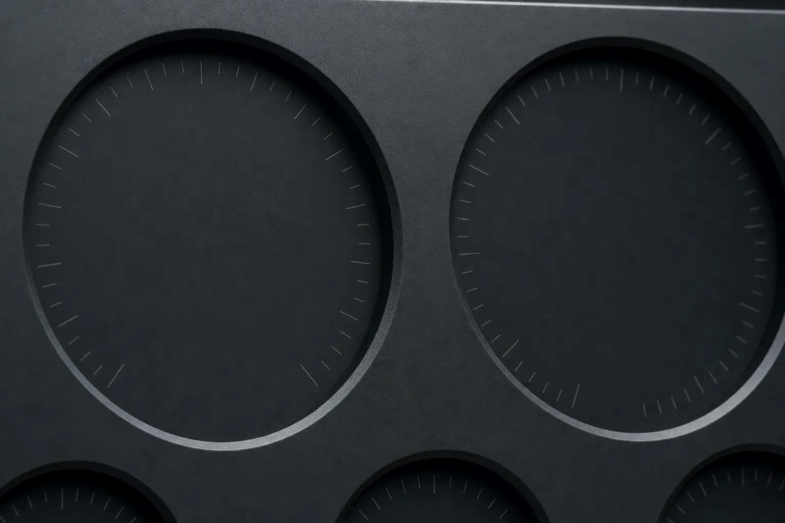 Flat dark instrument panel with faint engraved tick marks and no switches.